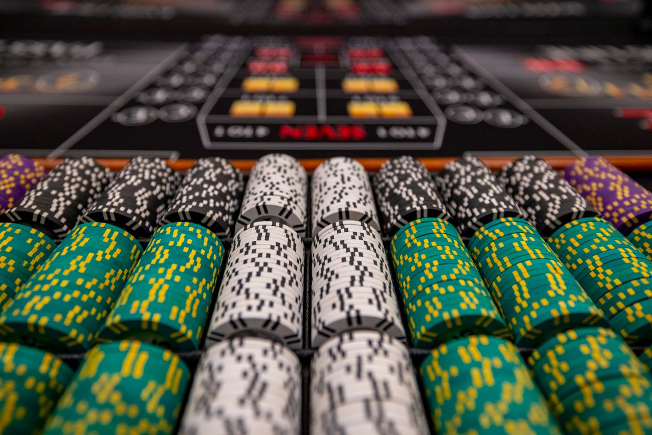 Close-up of colorful casino chips arranged on a gaming table, ready for play.